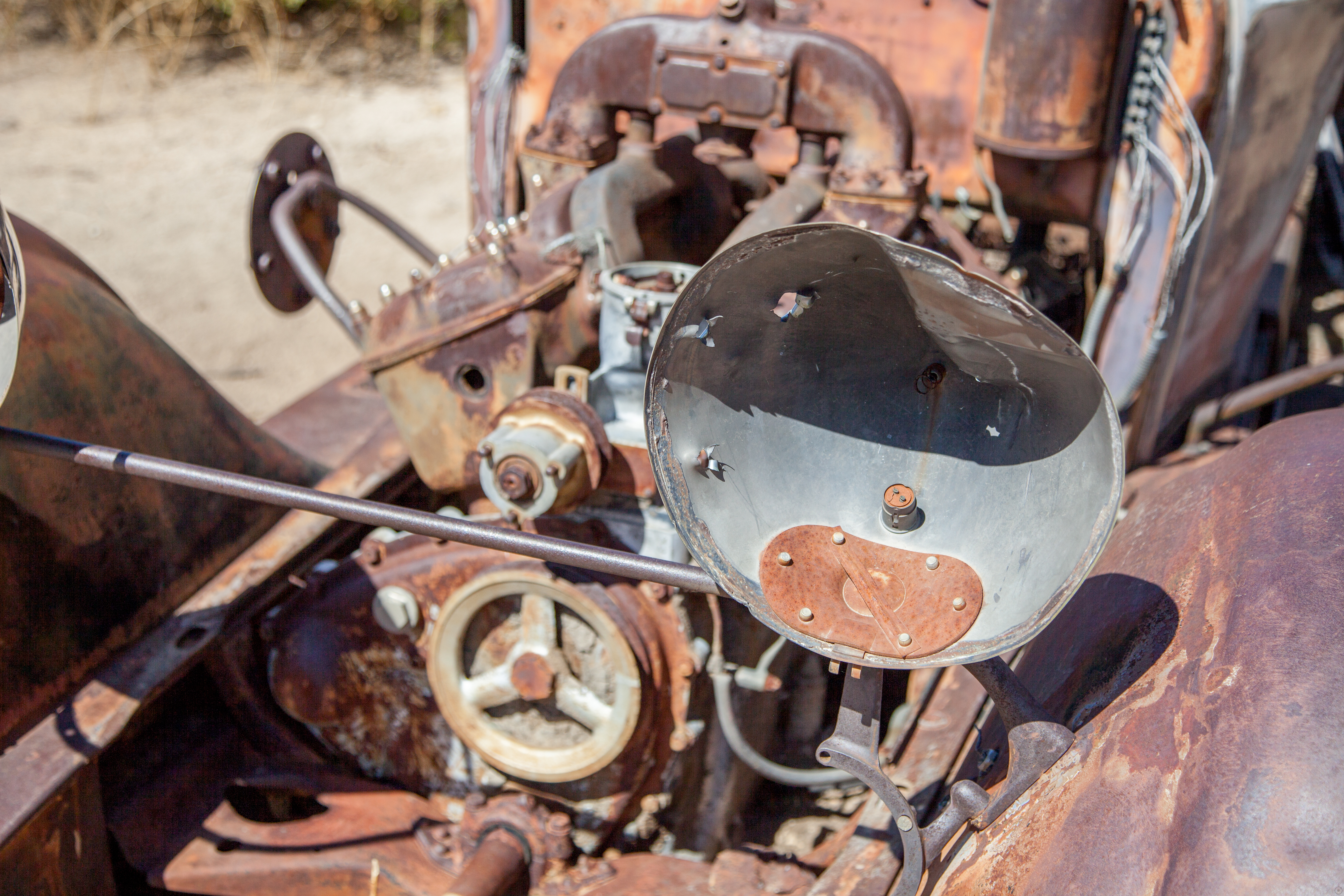 a view of a rusted out engine in the desert
