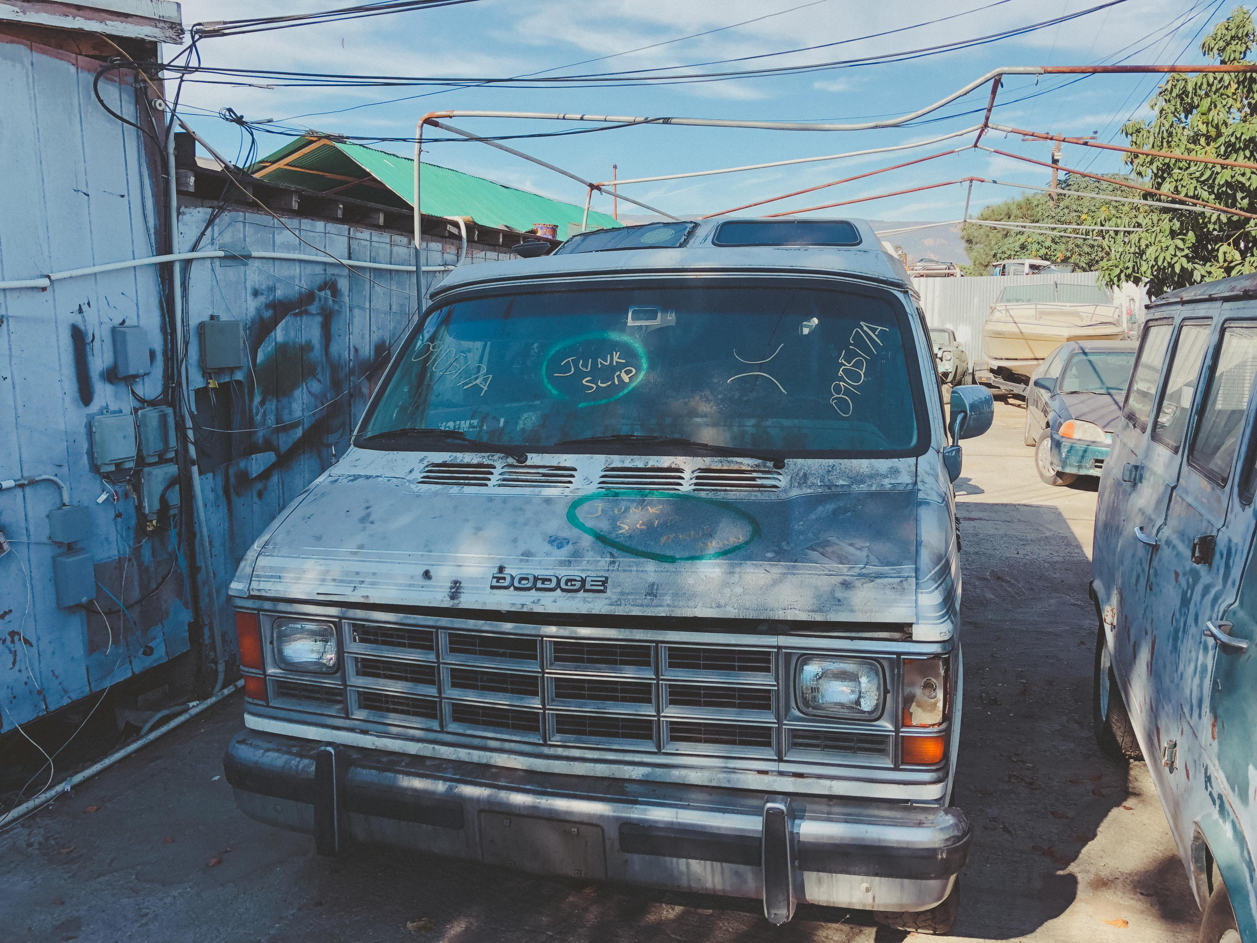 a 1990 Dodge Roadtrek in a junkyard